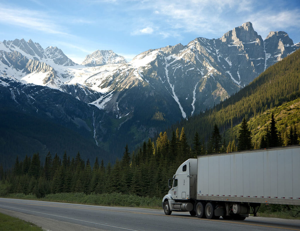 Semi truck driving through the mountains